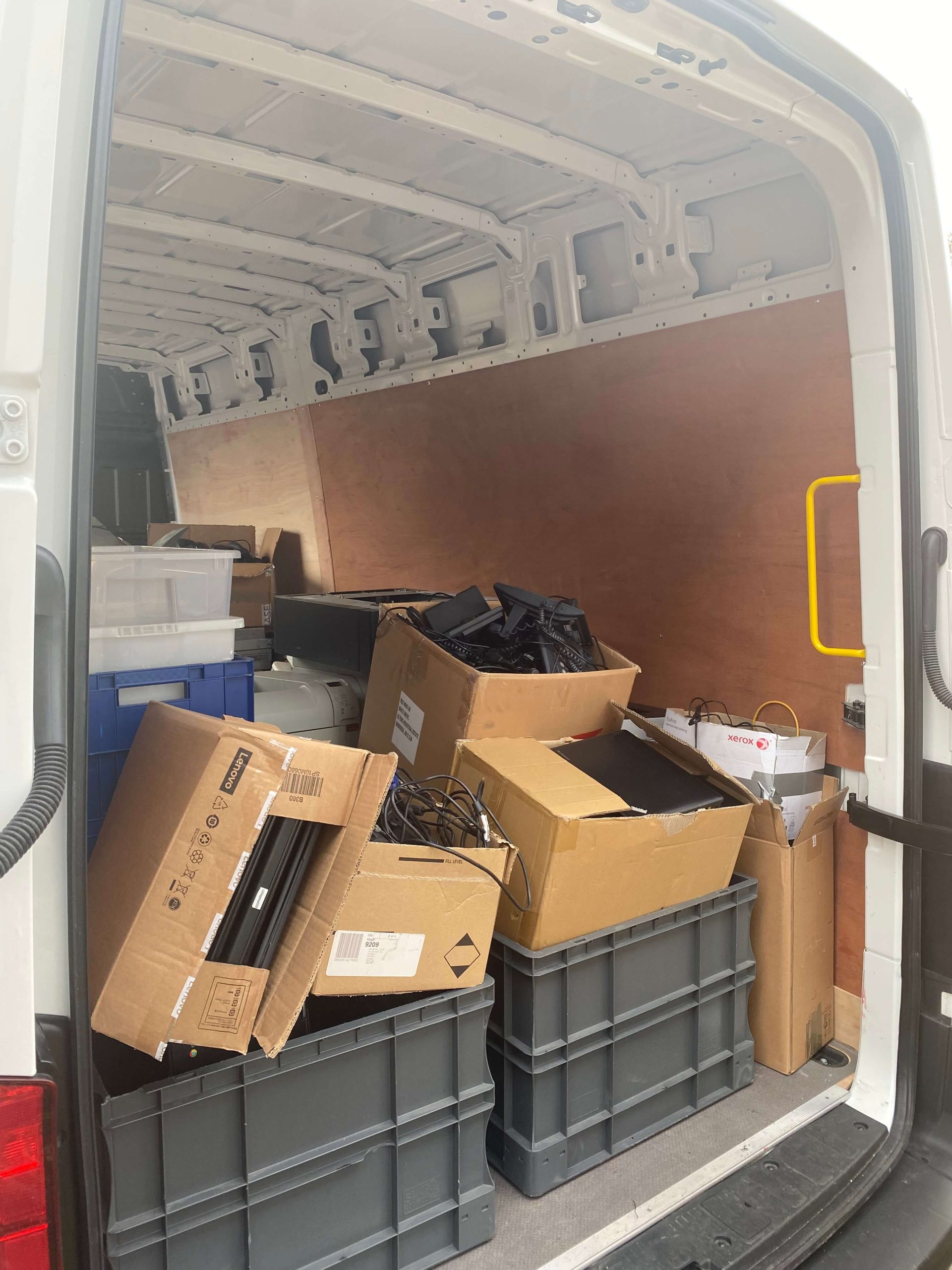 van filled with unused text in cardboard boxes