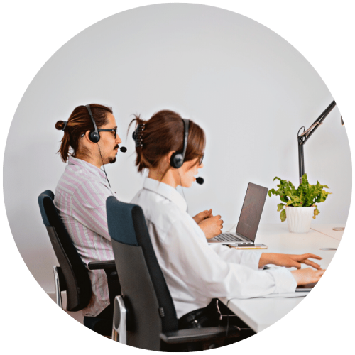 Support workers with their headsets on at their desk