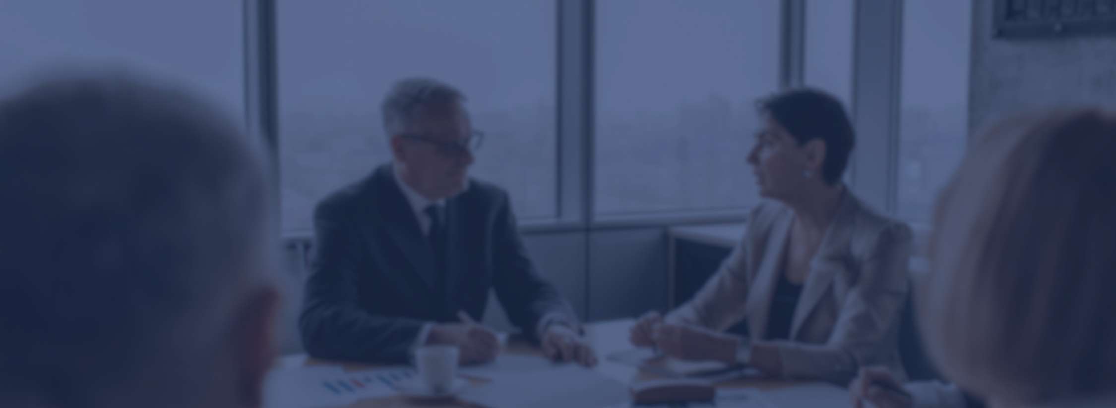 people talking in boardroom with blue overlay effect