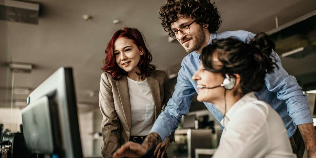 Team looking at computer